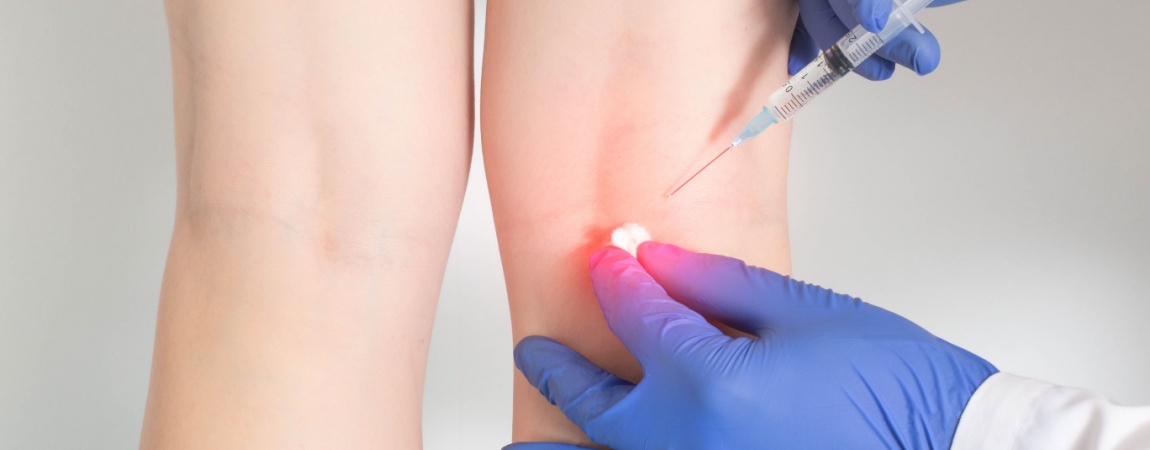 Medic administreaza injectie in articulatia umarului pacientului in cadrul unei proceduri medicale.