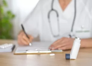 Doctor care scrie o reteta pentru tratamentul astmului si al alergiilor