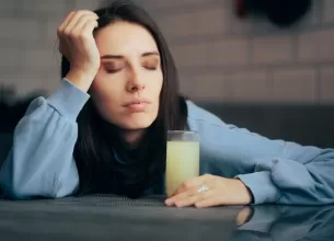 Femeie obosita consuma o bautura efervescenta cu suplimente de calciu si minerale