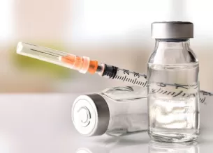 Flacoane cu medicamente si seringa pregatita pentru administrarea tratamentului