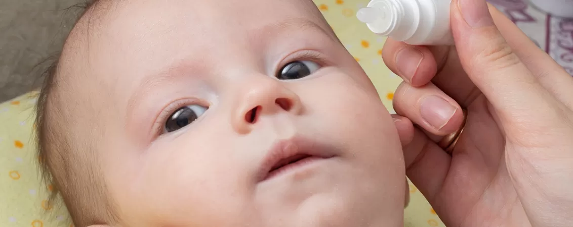 Specialist medical aplicand tratament pentru conjunctivita unui bebelusi