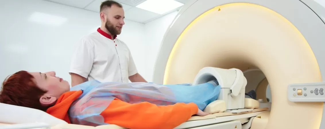Asistent langa pacienta pregatita pentru RMN genunchi