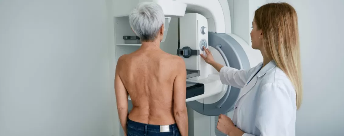 Pacienta efectuand o mamografie, ca test de screening pentru cancerul de san