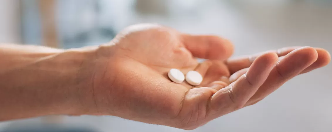 Mana unei femei tinand pastile de ivabradina