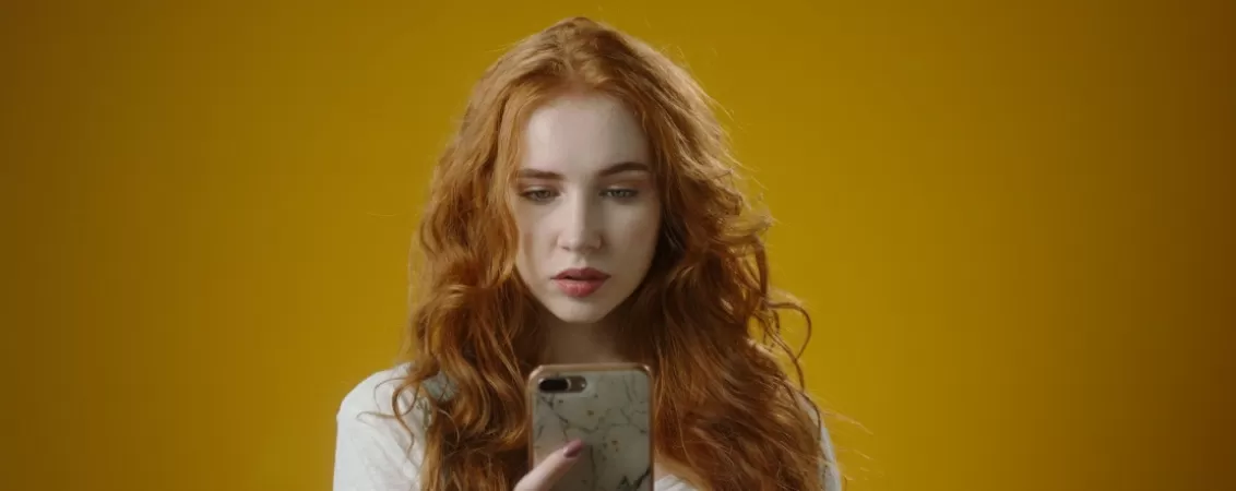 Femeie tanara concentrata la telefonul mobil